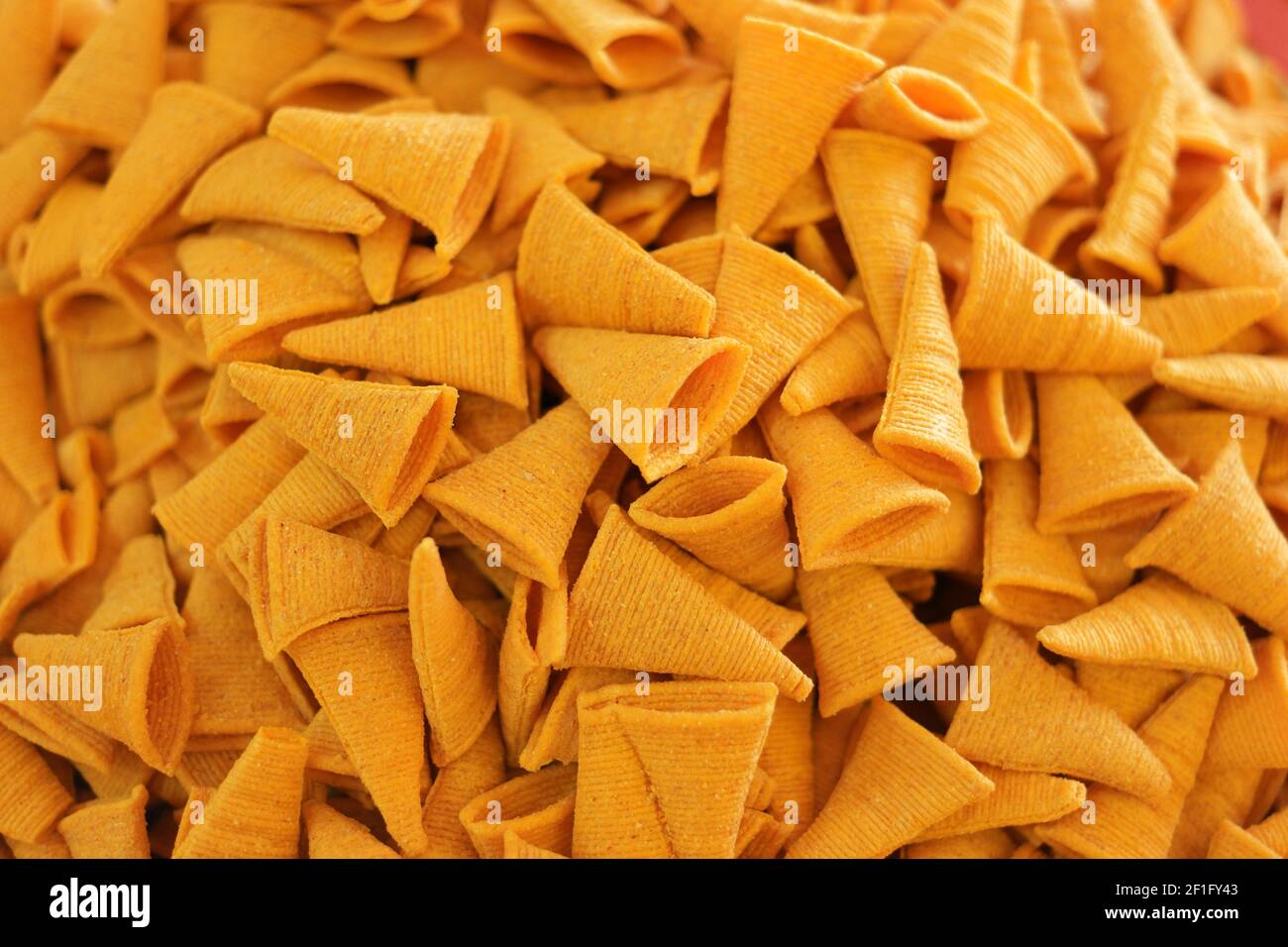 Triangle crunchy corn cheese flavor snack background Stock Photo Alamy