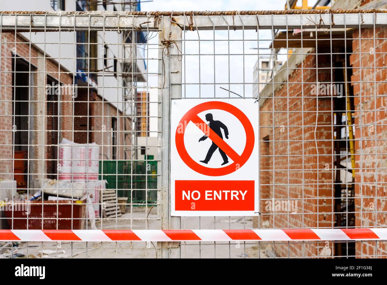 Closed access door to the construction site of a building with a