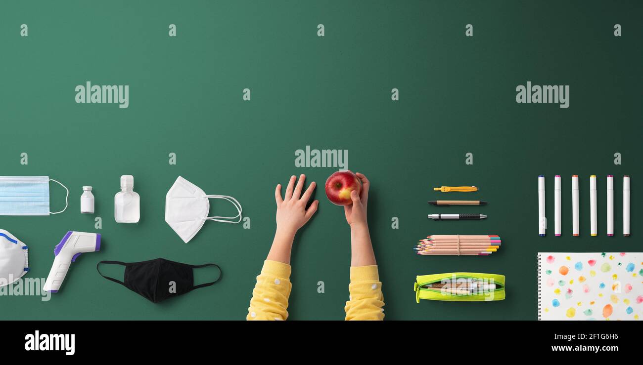 Flat lay top view of face mask and school supplies, back to school and ...
