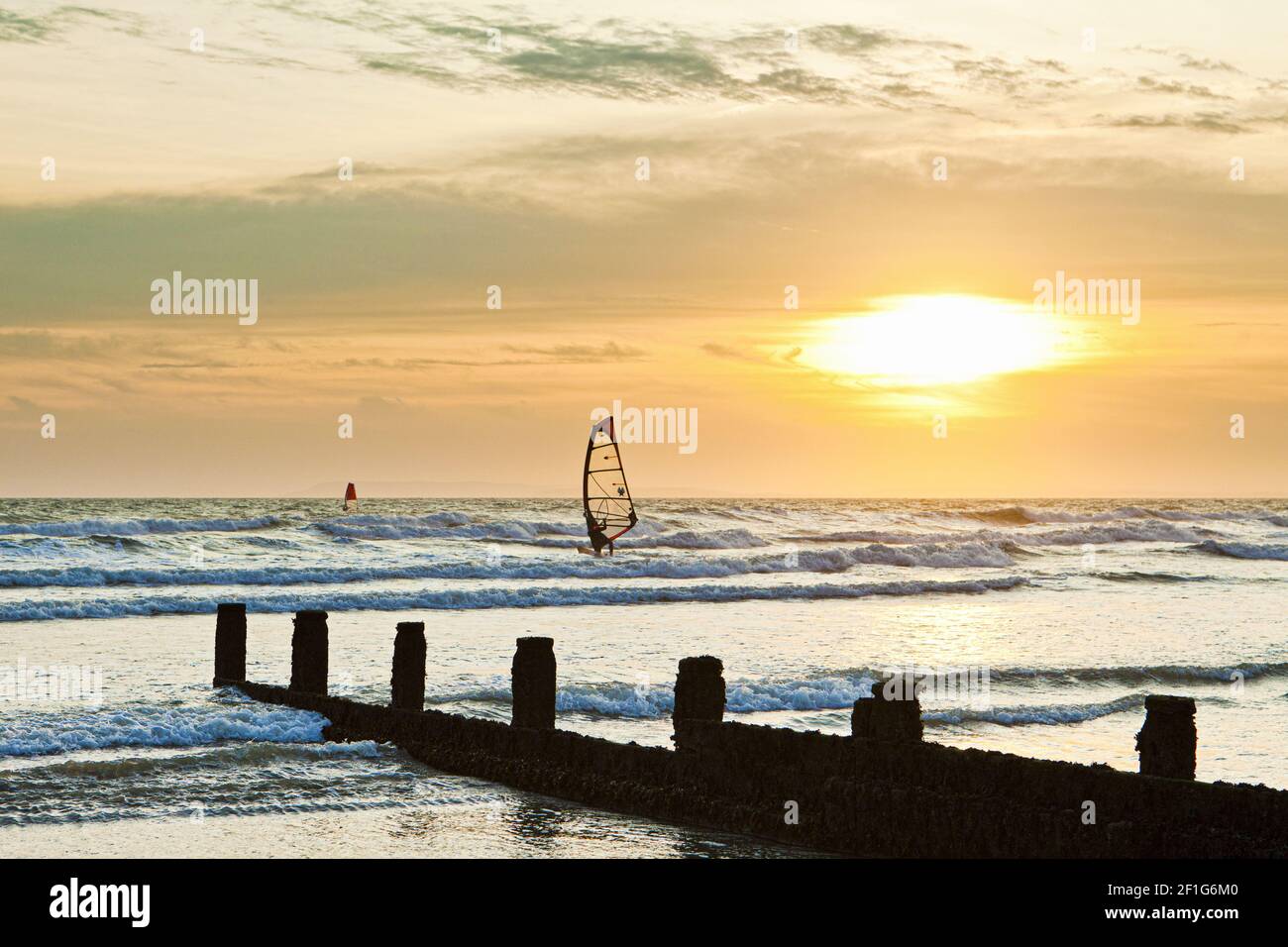 Sunset over the English Channel with windsurfers, viewed from the south coast resort of Bracklesham, Sussex UK Stock Photo