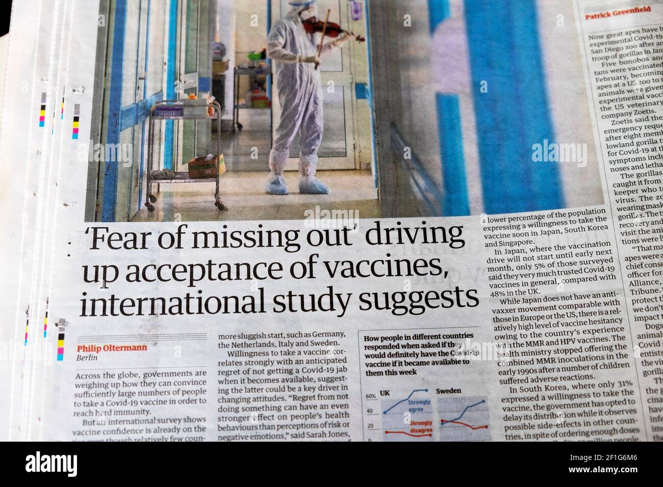 ' 'Fear of missing out' driving up acceptance of vaccines, international study suggests' article in Guardian newspaper headline 6 March 2021 London UK Stock Photo