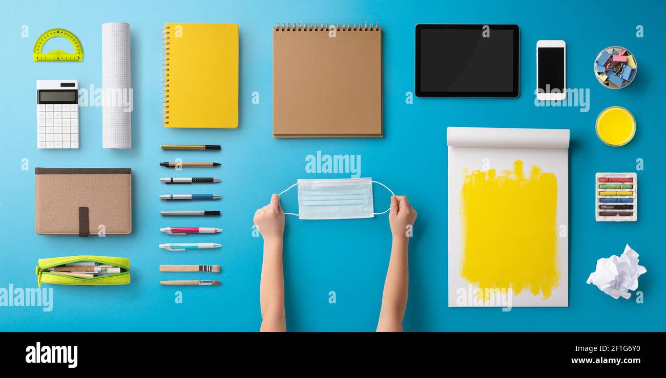 Flat lay top view of face mask and school supplies, back to school and ...