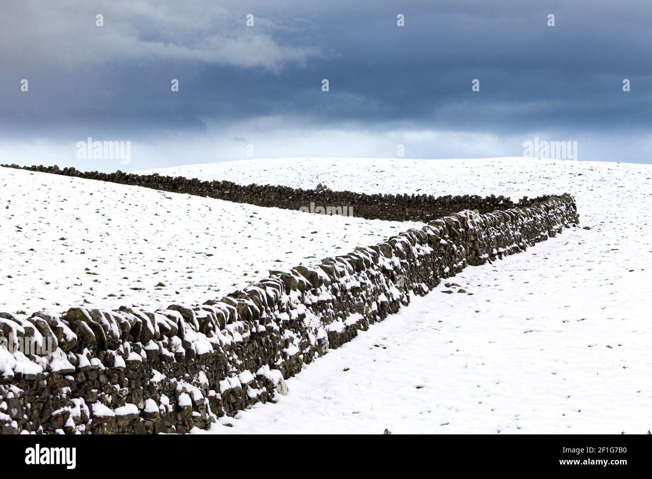 Snow clouds over a dry stone wall on the Pennines near Hartside Height, Cumbria UK Stock Photo