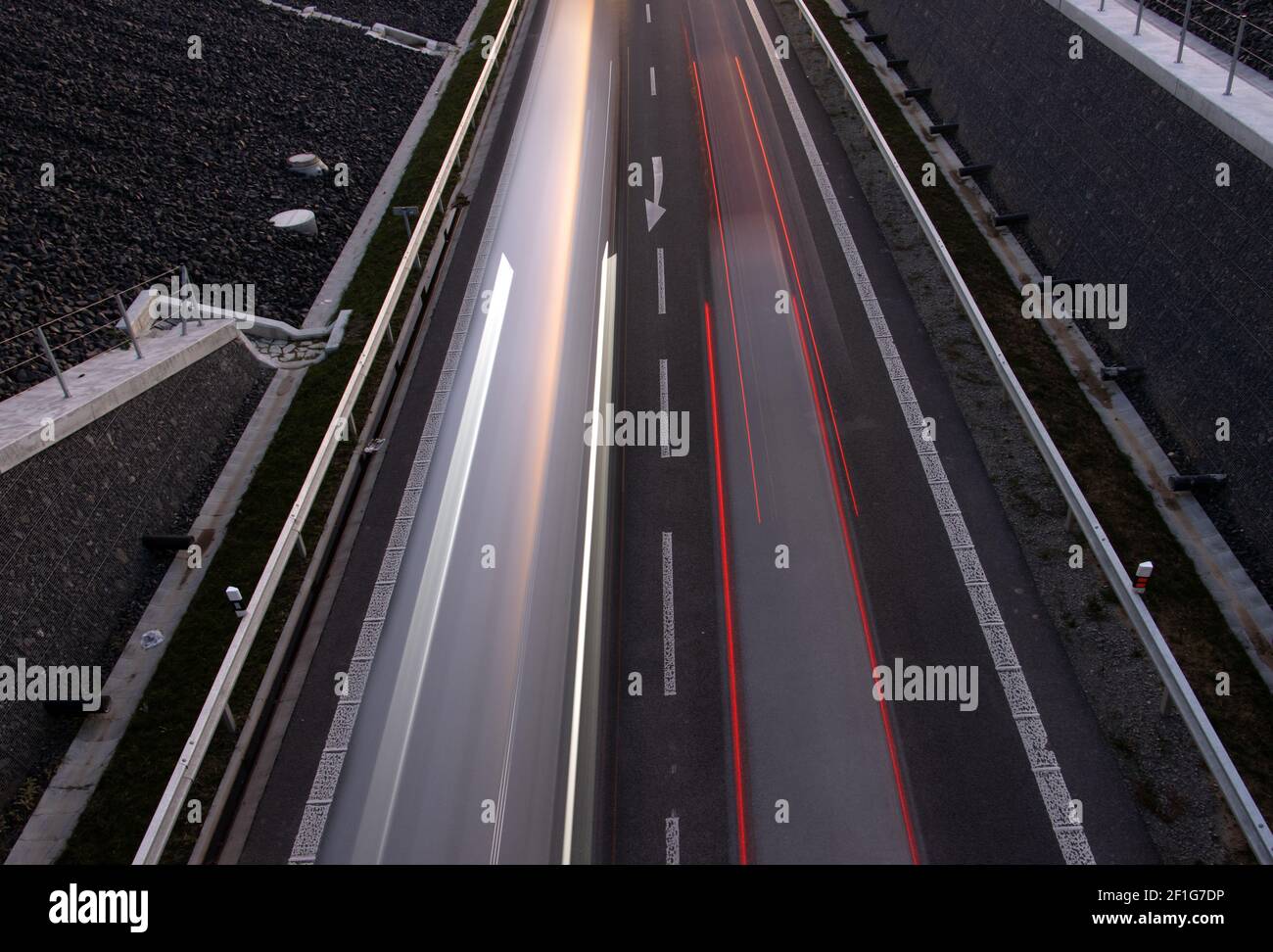 Cars lights driving on the evening road. Top view of traffic on a road