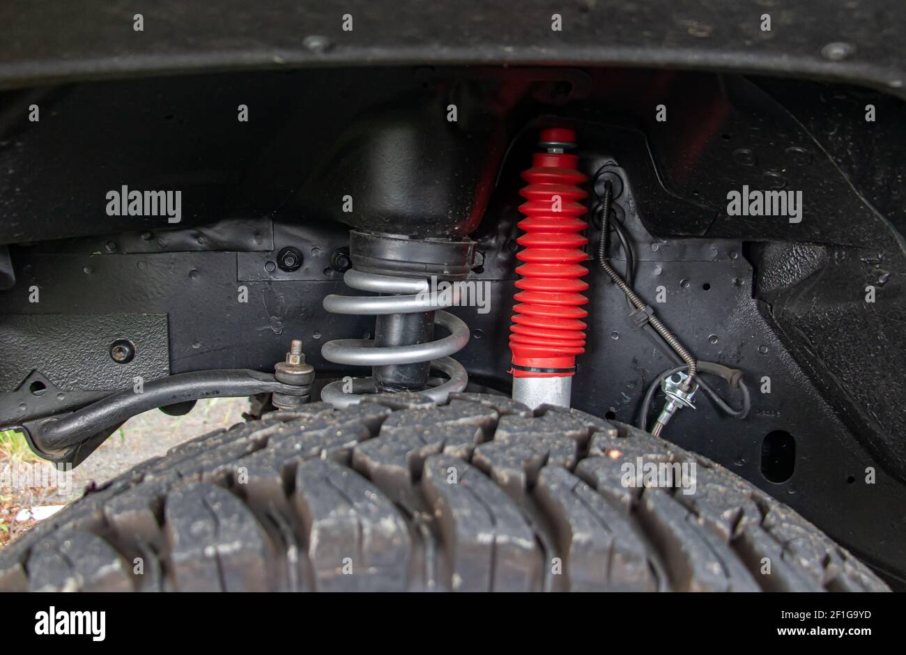 Off-road car chassis with a detailed view of the coil spring at the front wheel. Stock Photo