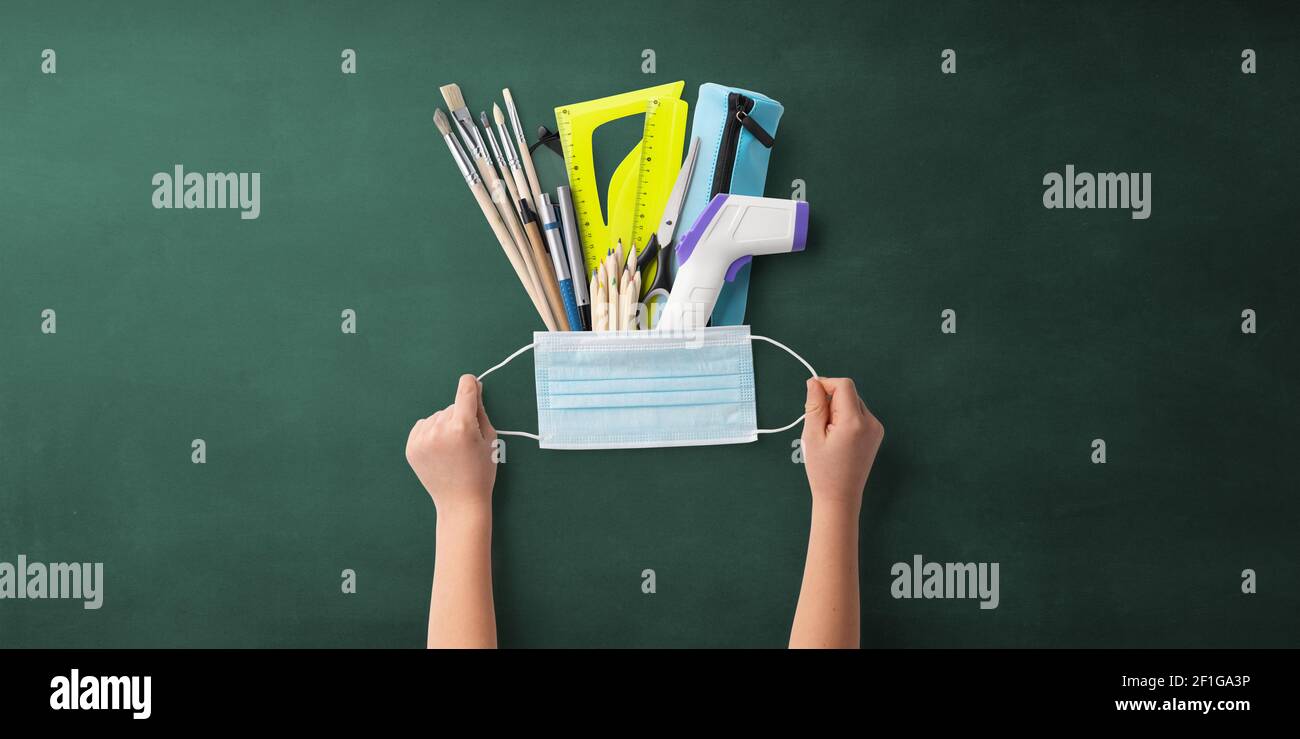 Flat lay top view of face mask and school supplies, back to school and ...
