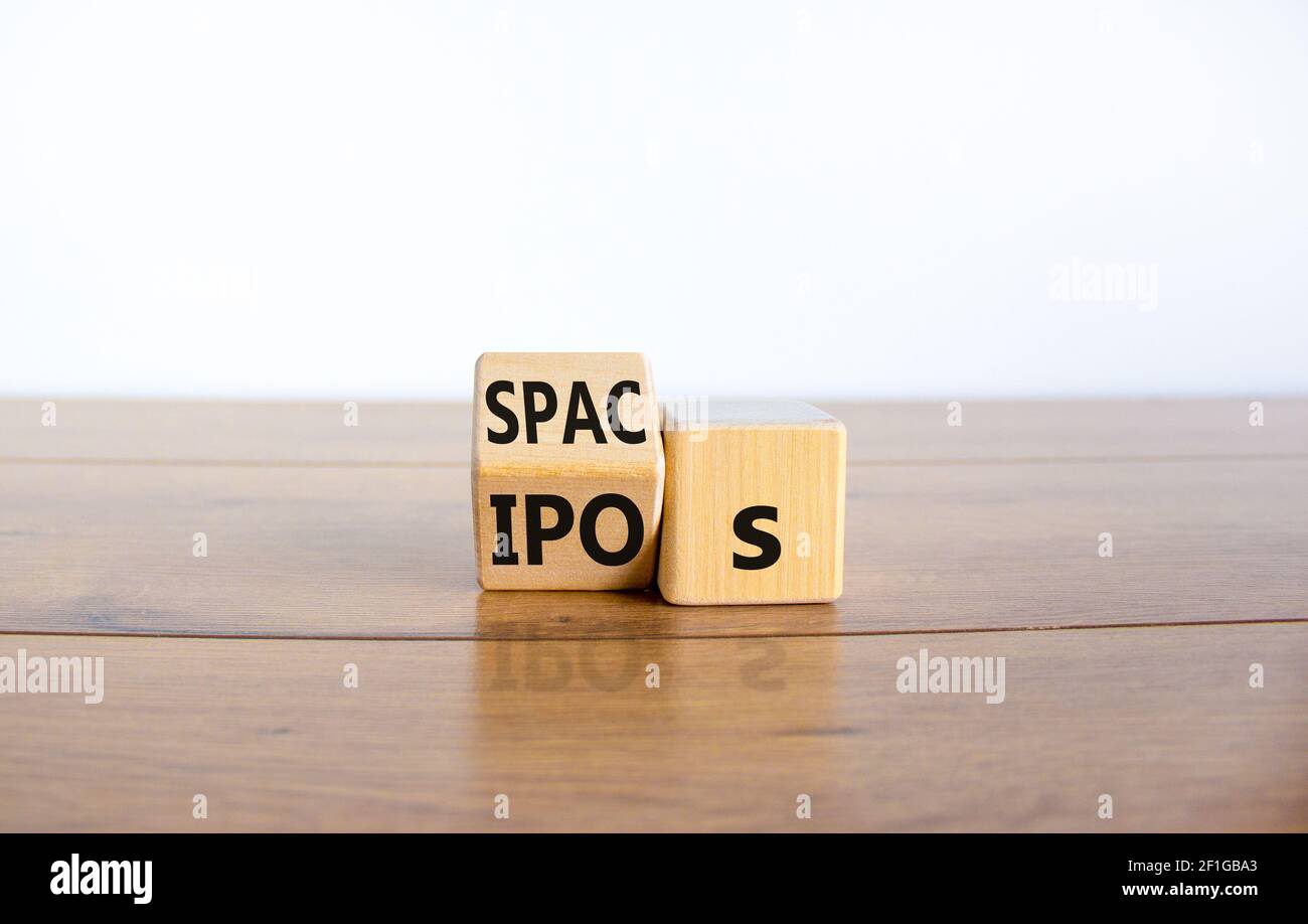 SPACs vs IPOs symbol. Cubes with words 'SPACs, special purpose acquisition companies' and 'IPOs, initial public offering' on beautiful white backgroun Stock Photo