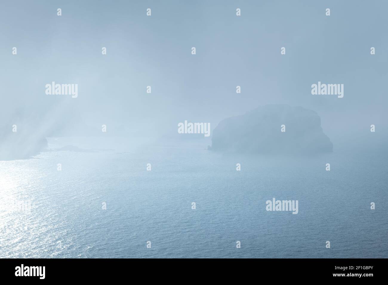 Gaztelugatxe from Machichaco Cape on a foggy day, Basque Country in Spain Stock Photo