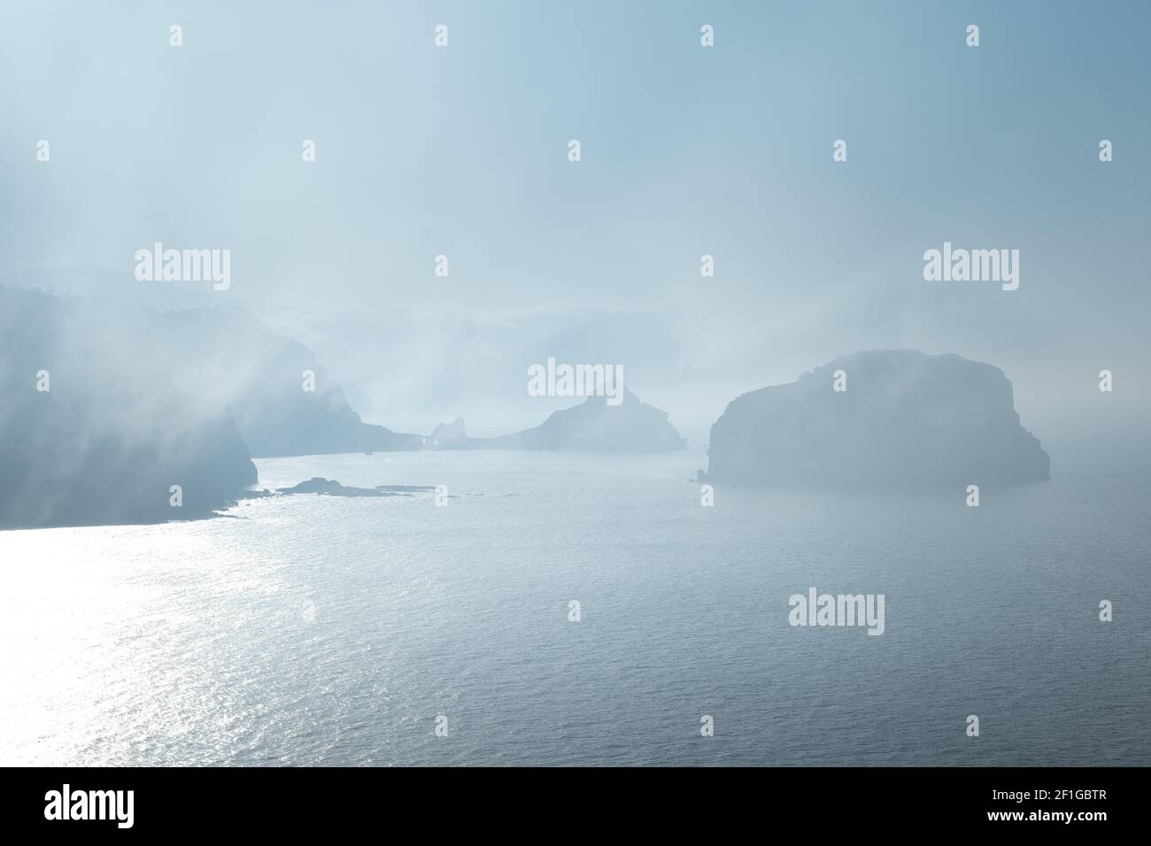 Gaztelugatxe from Machichaco Cape on a foggy day, Basque Country in Spain Stock Photo