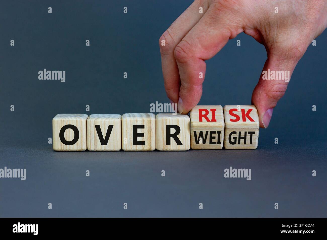High risk from overweight symbol. Doctor turns wooden cubes and changes ...