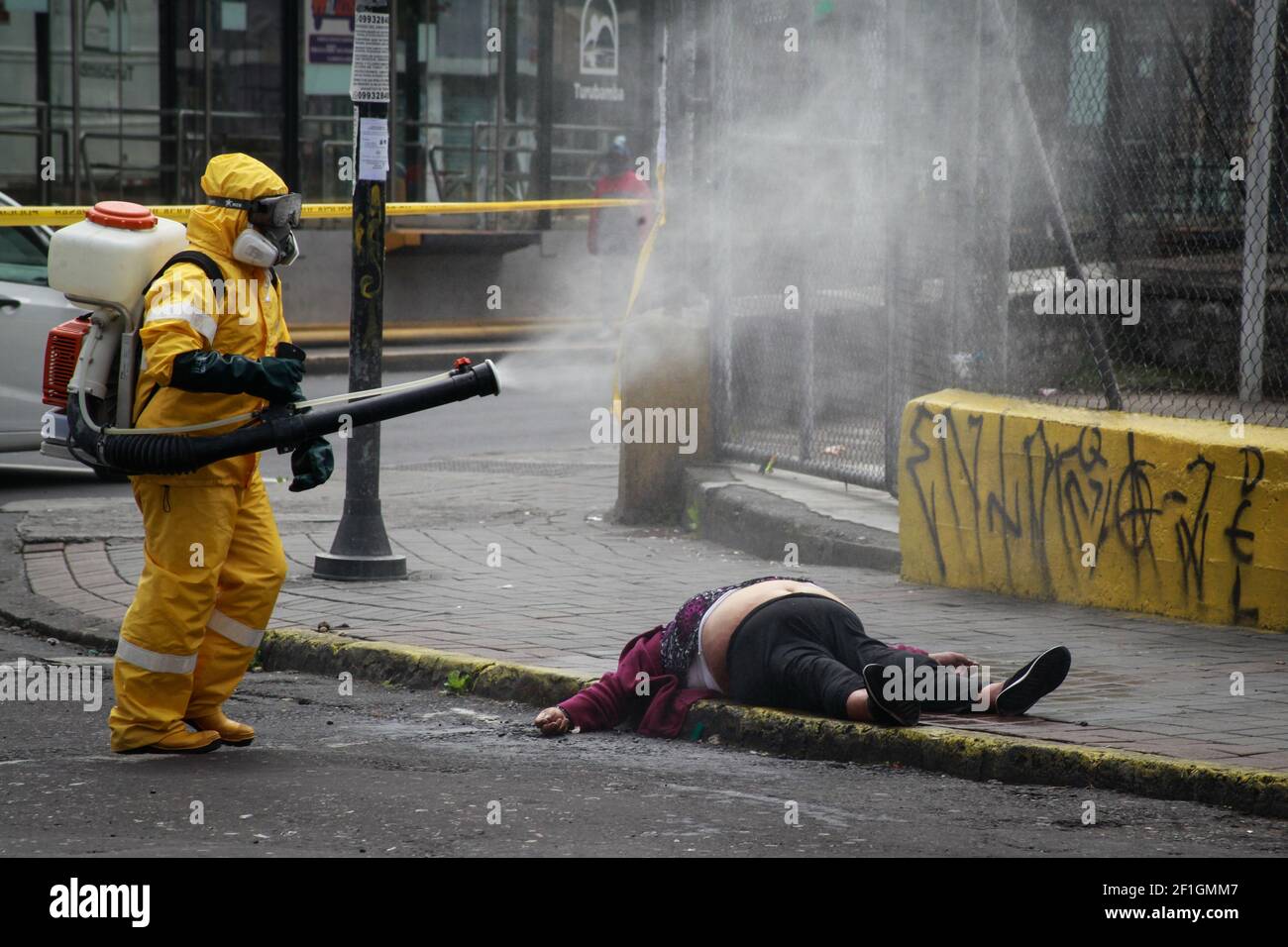 (EDITORS NOTE: Image depicts death)Biosafety personnel disinfects the body of a person who died due to the coronavirus disease (COVID-19) on the street. Stock Photo