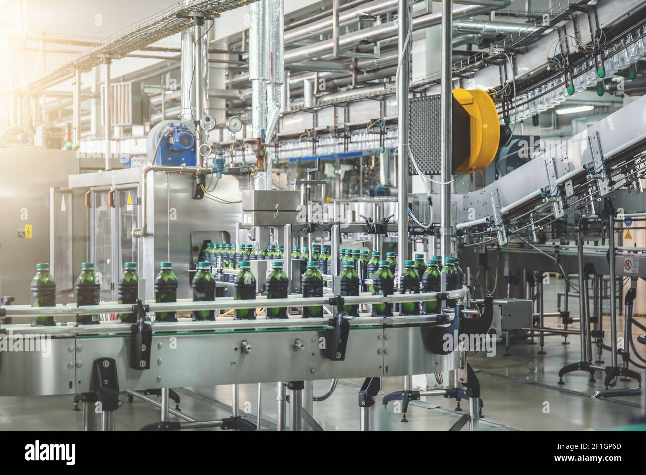 Conveyor belt with juice in bottles, Beverage factory, production line process. Stock Photo