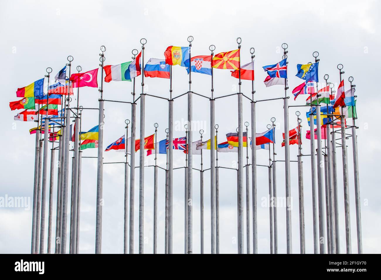 Flags of European states on flagpoles against blue sky background Stock ...