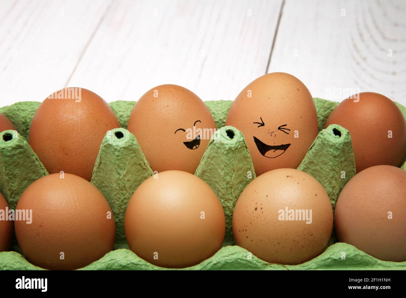 Emotional chicken eggs in a tray. Different grimaces drawn on chicken eggs Stock Photo