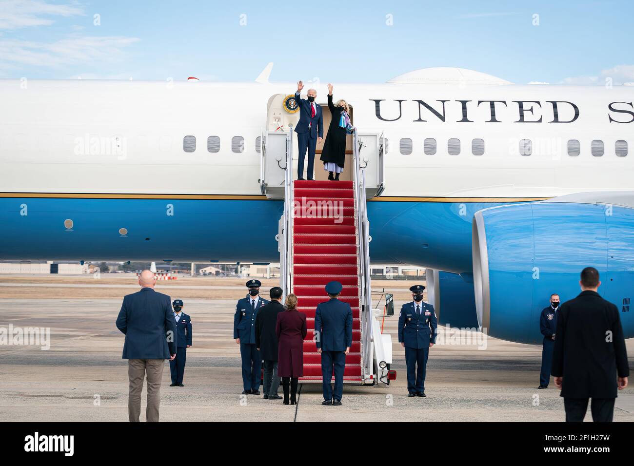 President Joe Biden and First Lady Jill Biden wave as they board Air ...