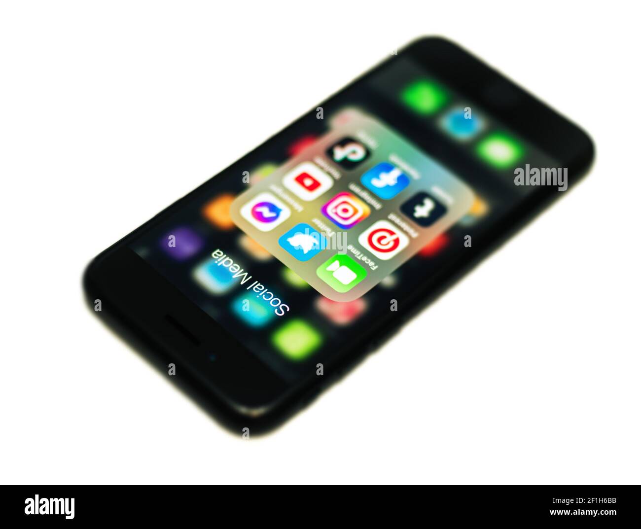 2020: Apple  iPhone 7 black smartphone showing the Social Media icons bundle, lies on white Stock Photo