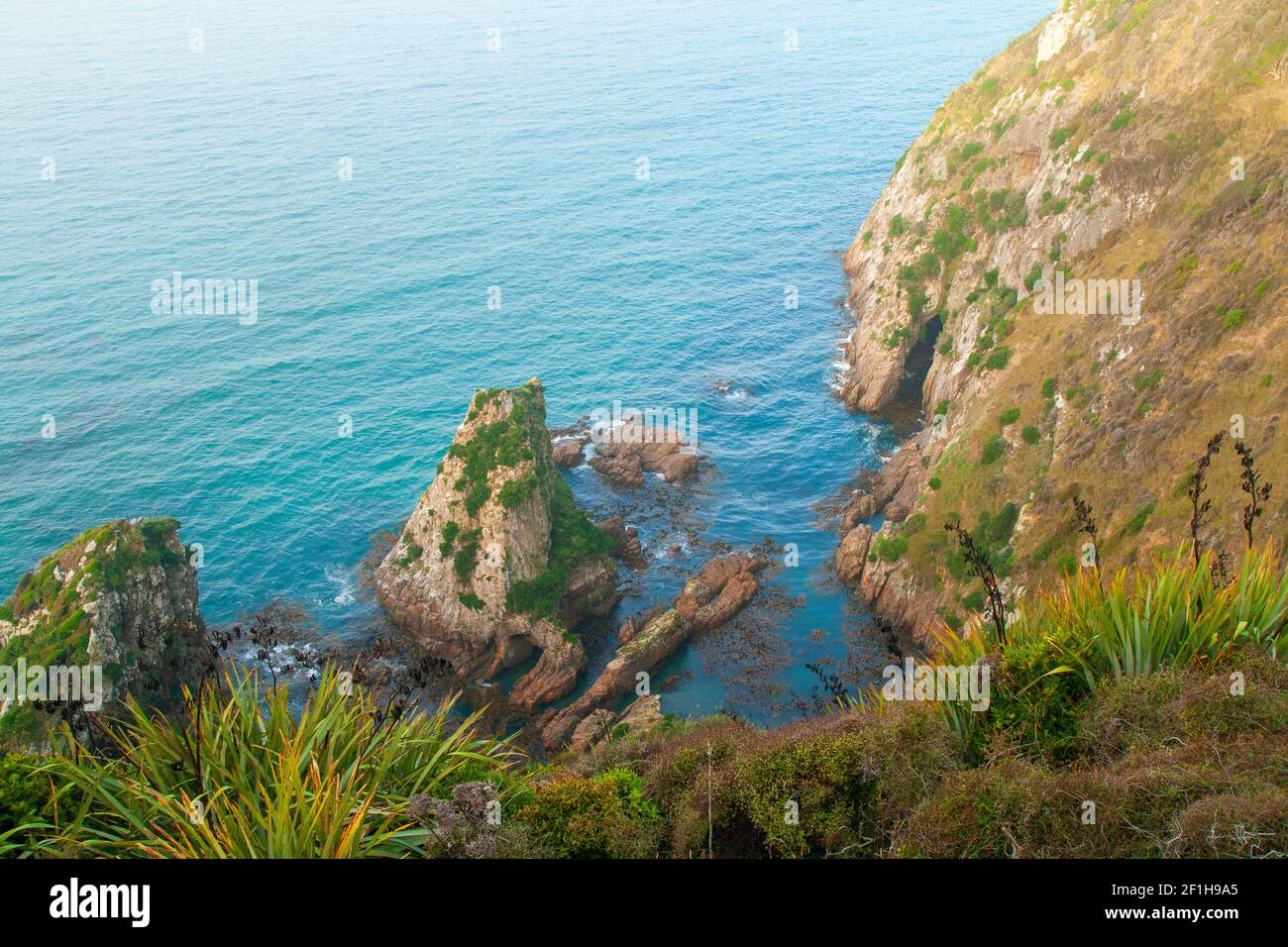Ocean cliff top view from the edge, deep blue waters of southern Pacific Ocean, Nugget Point New Zealand Stock Photo