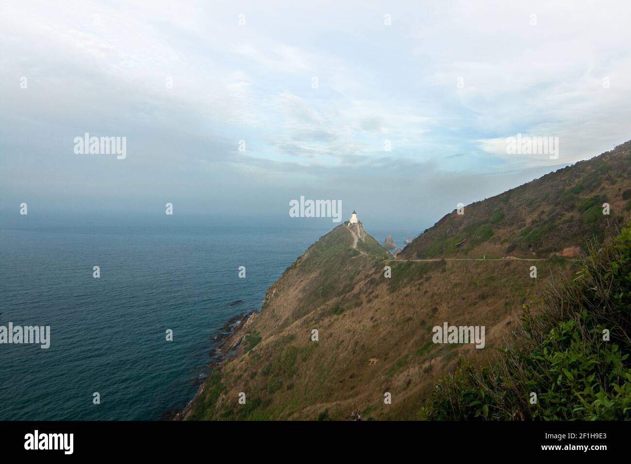 Nugget Point lighthouse landscape of dreamatic Pacific Ocean coast, tokata walk, Southland New Zealand Stock Photo