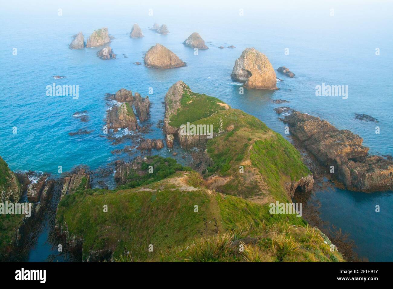 The nuggets- rocky islets of Nugget Point New Zealand, wild Southern Pacific Ocean at the Catlins coast, South Island of New Zealand Stock Photo