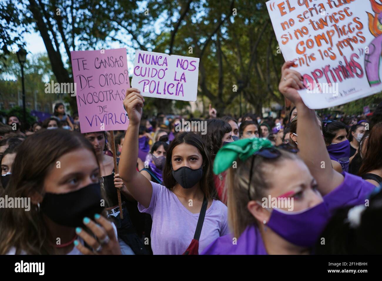 Participants hold up signs to mark International Women's Day during a march  down Avenida 18 de Julio in downtown Montevideo, Uruguay March 8, 2021. The  signs read (L) "Are you tired of