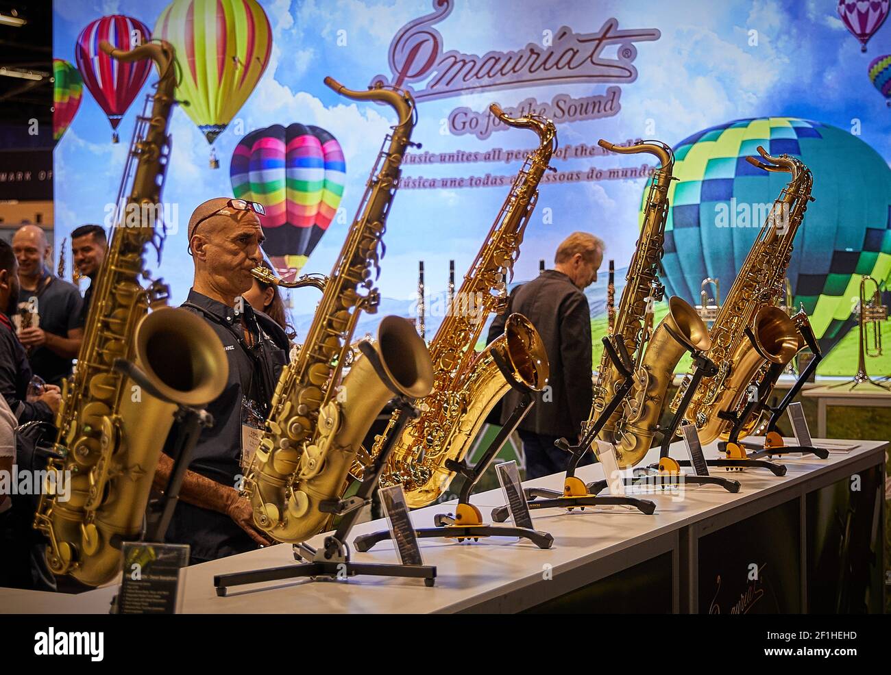 Man Playing saxophone at Musical Instrument Convention Stock Photo