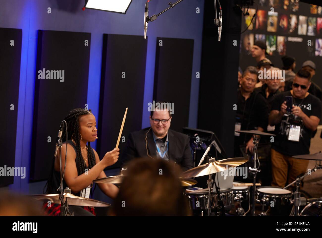 Female Drummer performing at Musical Instrument Convention Stock Photo