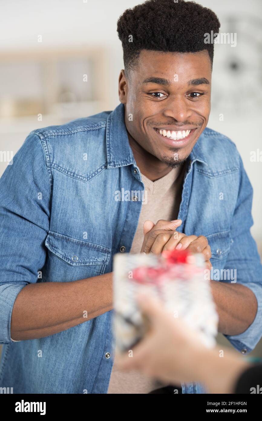 happy man receiving a present Stock Photo - Alamy