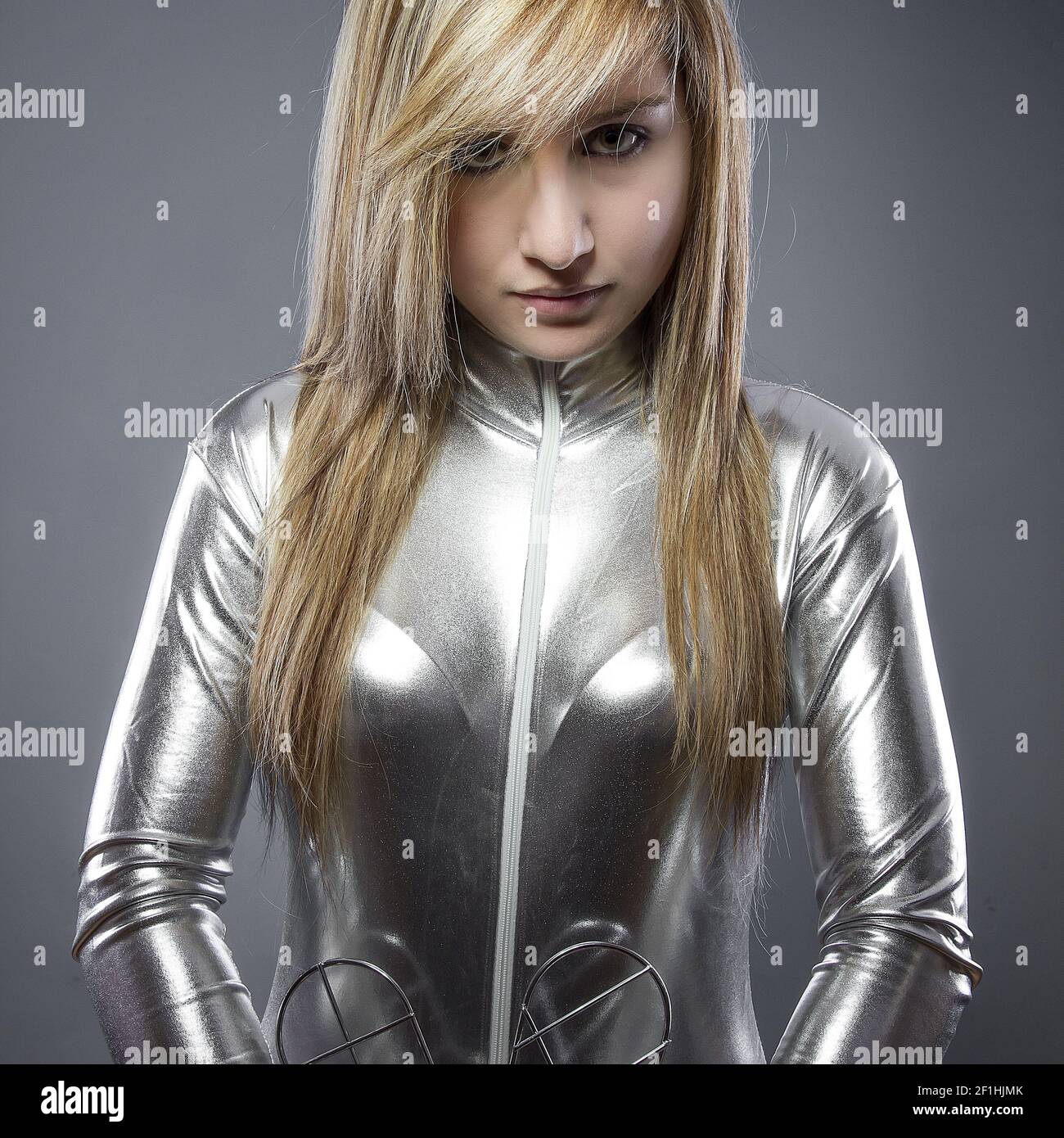 Blonde woman dressed in silver-plated jumpsuit, woman of the future Stock Photo