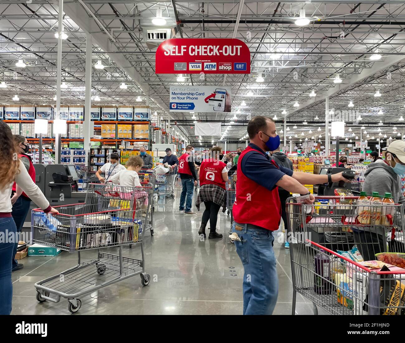 McKinney, TX USA - February 22, 2021: Costco employees helping customers to check out at a new opened self check-out area in McKinney location Stock Photo