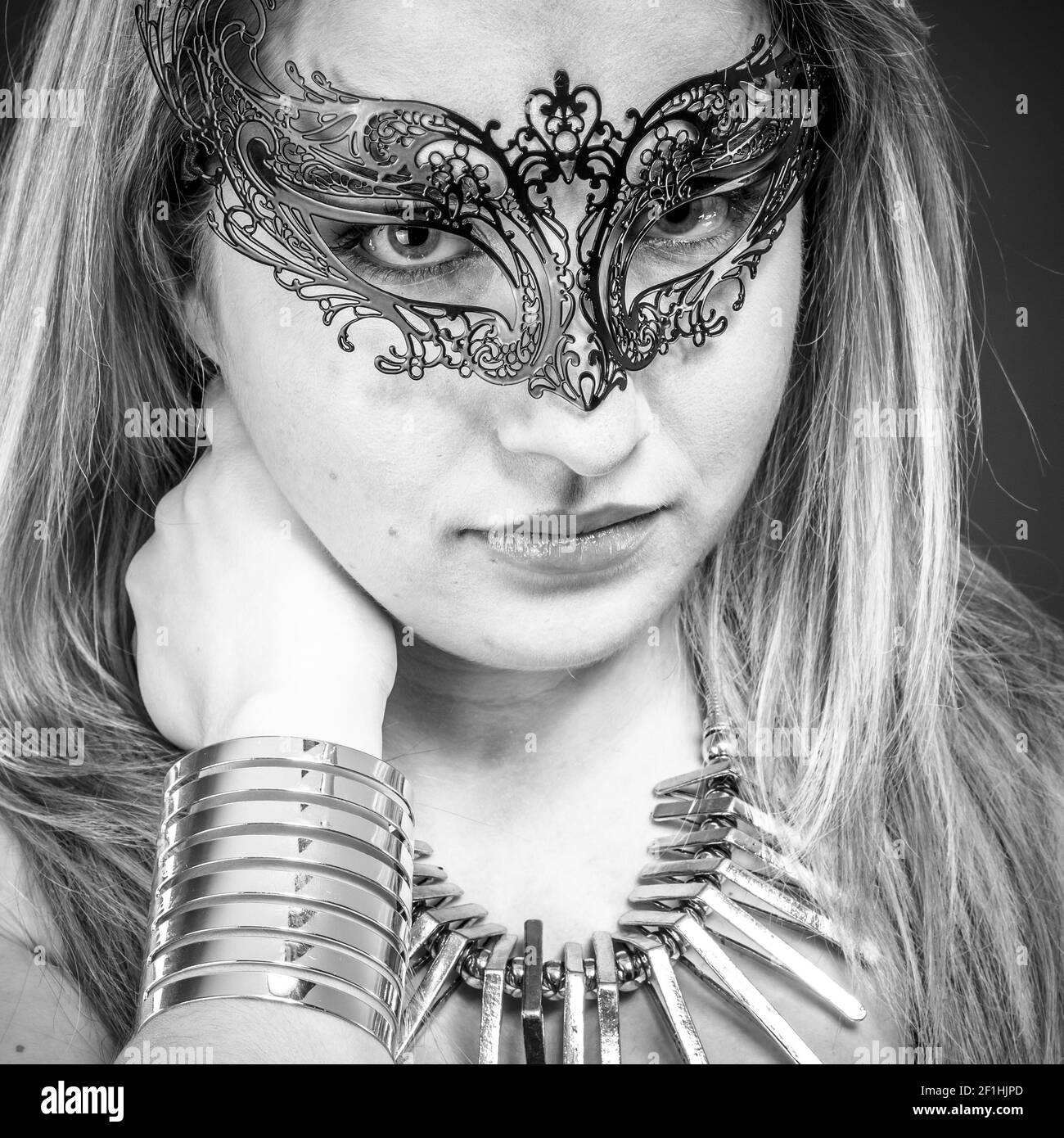 Gold, Beautiful blonde with silver jewelry and mask Stock Photo
