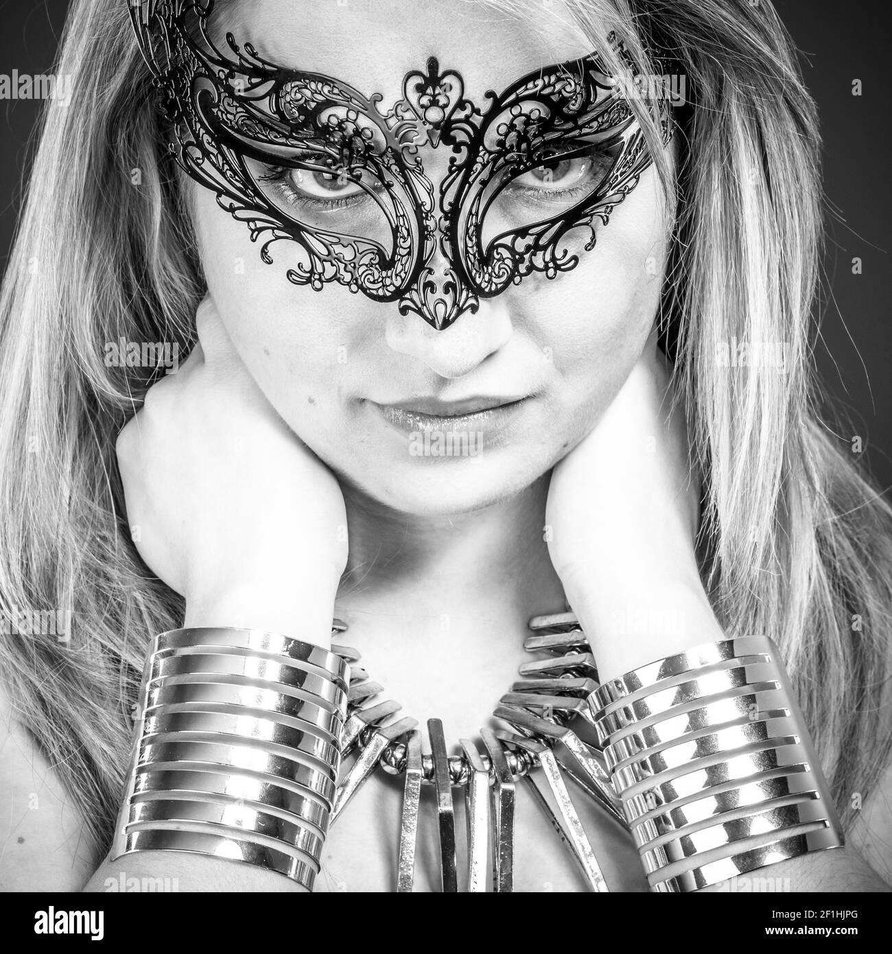Performer, Beautiful blonde with silver jewelry and mask Stock Photo