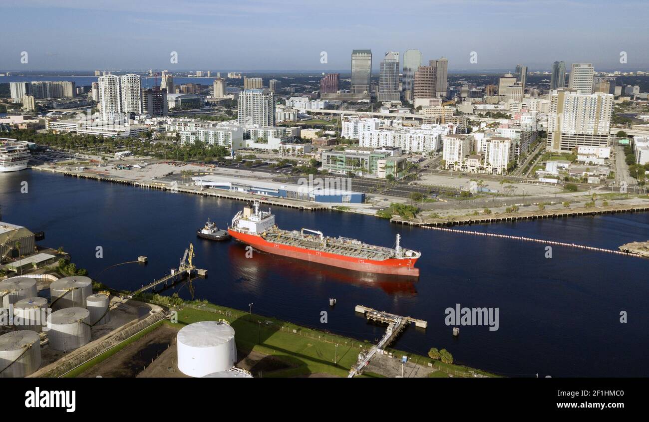 Little Tug Boats Do Double Duty Hauling Transport Ships in Port at Tampa Stock Photo