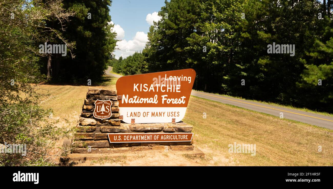 Two lane road passes exit sign to Kisatchie National Forest Stock Photo Alamy