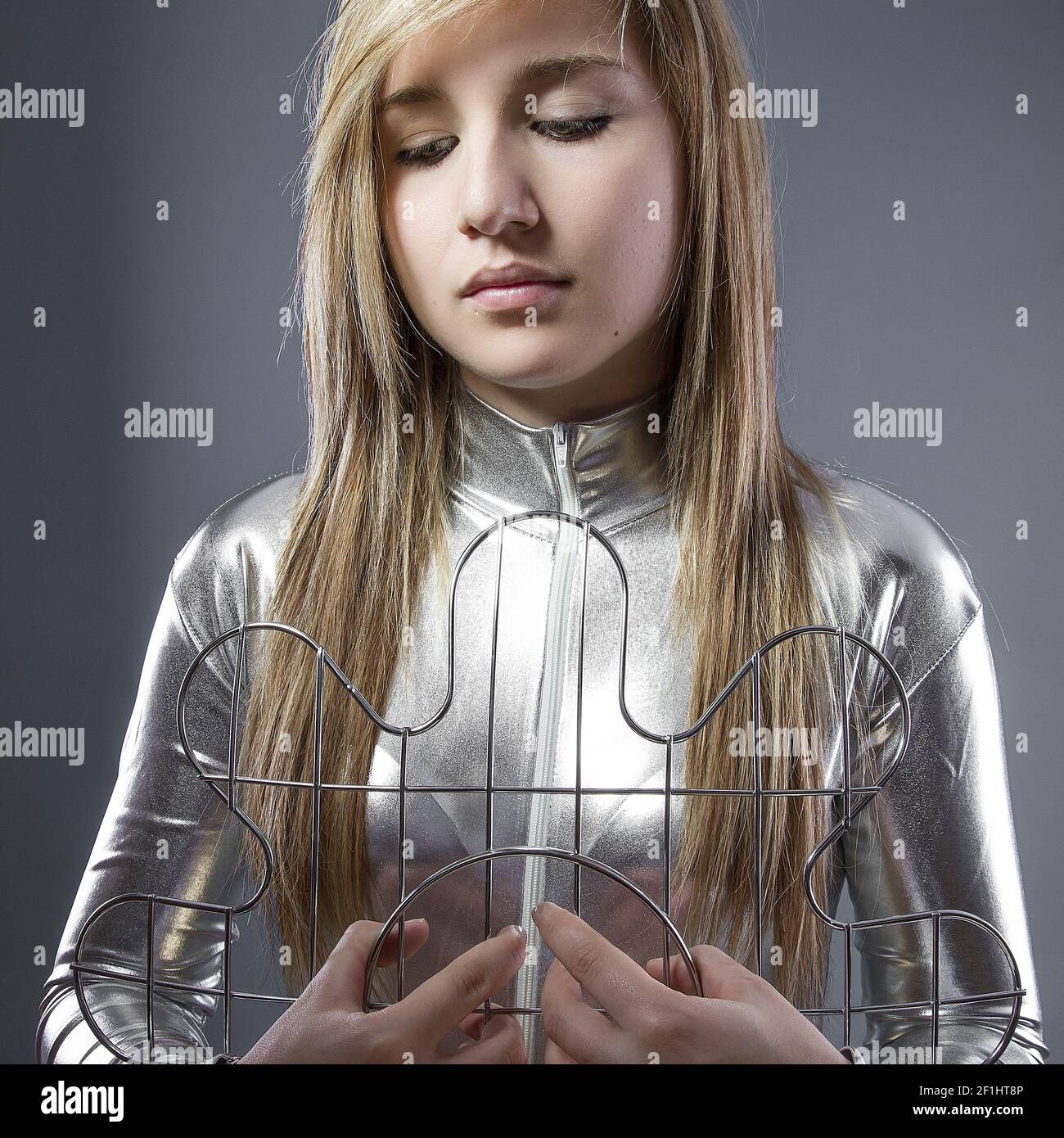 Blond woman of the future with silver-plated suit, concept new technologies and adaptation of the human being Stock Photo