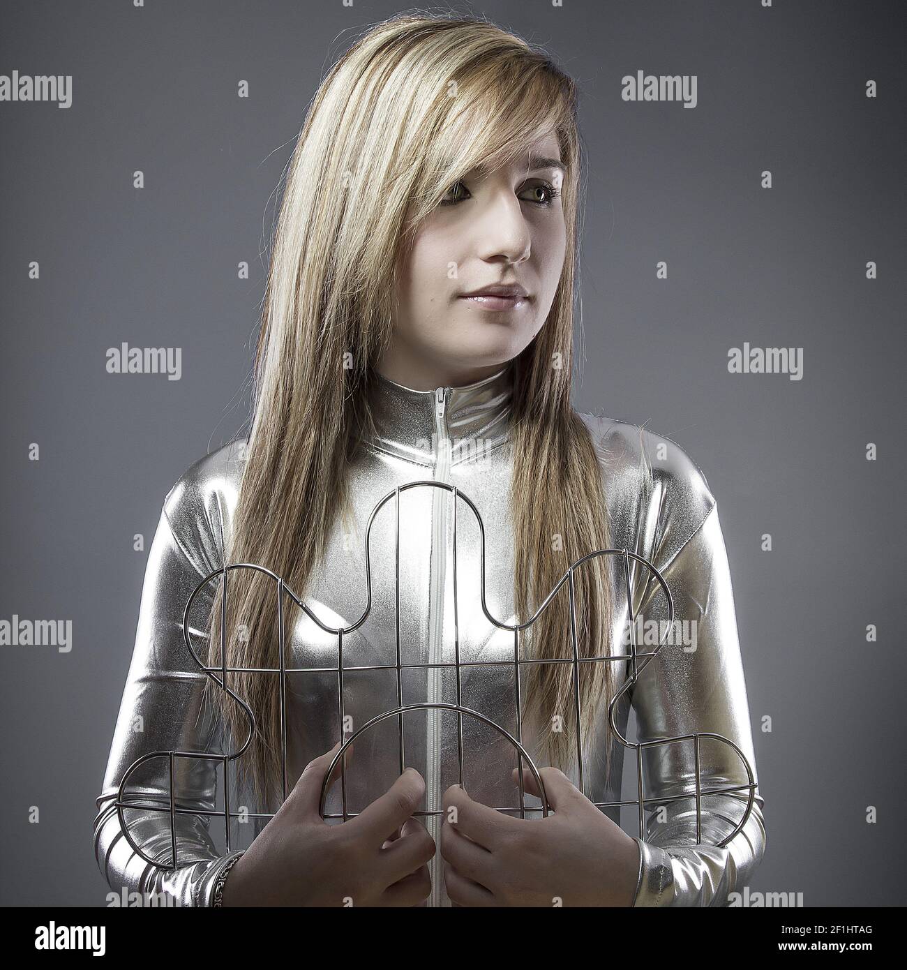 Blond woman of the future with silver-plated suit, concept new technologies and adaptation of the human being Stock Photo