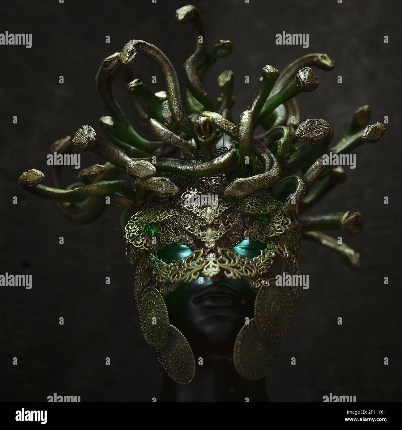 Head Medusa, creature of Greek mythology. pieces made by hand with goldsmiths and metals such as gold and copper. wears a helmet Stock Photo
