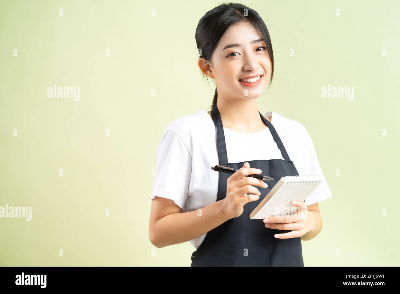Asian waitress holding a note in hand Stock Photo Alamy