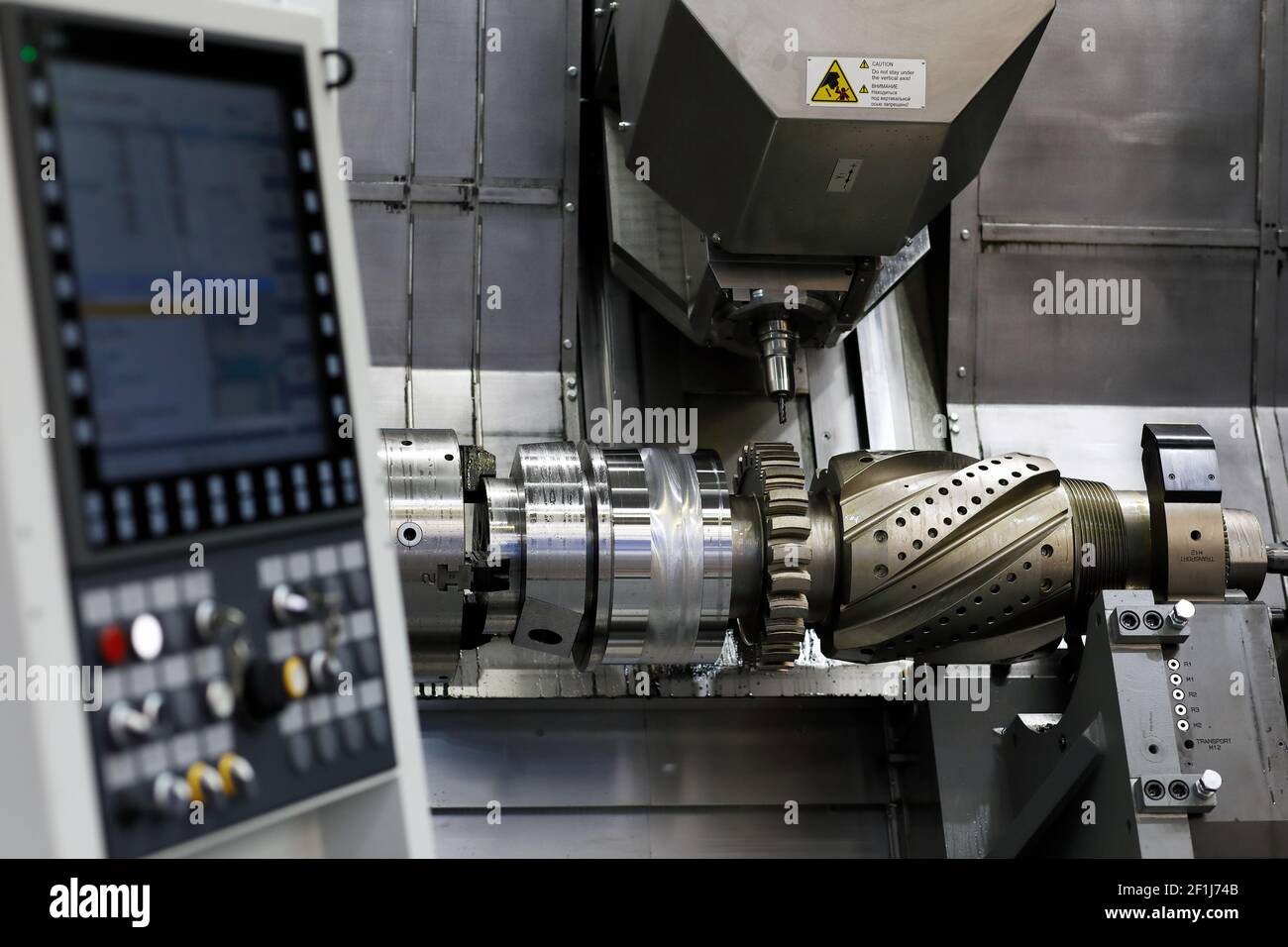 Gear shaft manufacturing process with CNC machining center. Selective focus Stock Photo Alamy