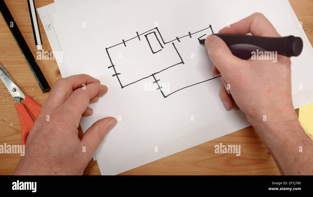 Top view, an interior designer's hand draws an ideal map for a new home, footage ideal for topics su Stock Photo
