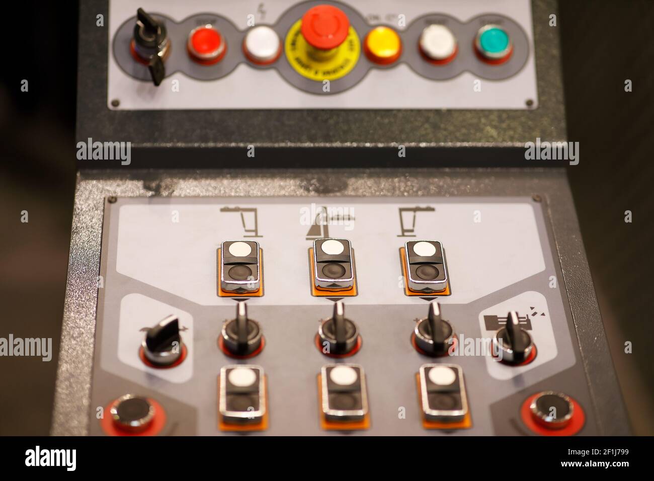 Push buttons and switches on a control panel of an industrial machine