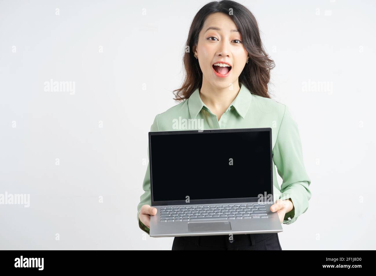 Portrait of a beautiful Asian businesswoman holding her laptop with an