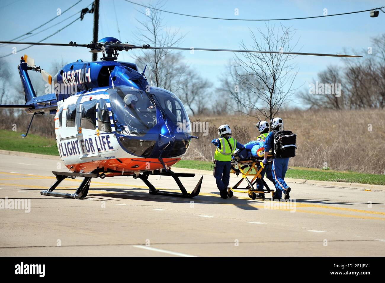 Bartlett, Illinois, USA. Following a serious car crash a victim being delivered, via stretcher, to a waiting helicopter for transport to a hospital. Stock Photo