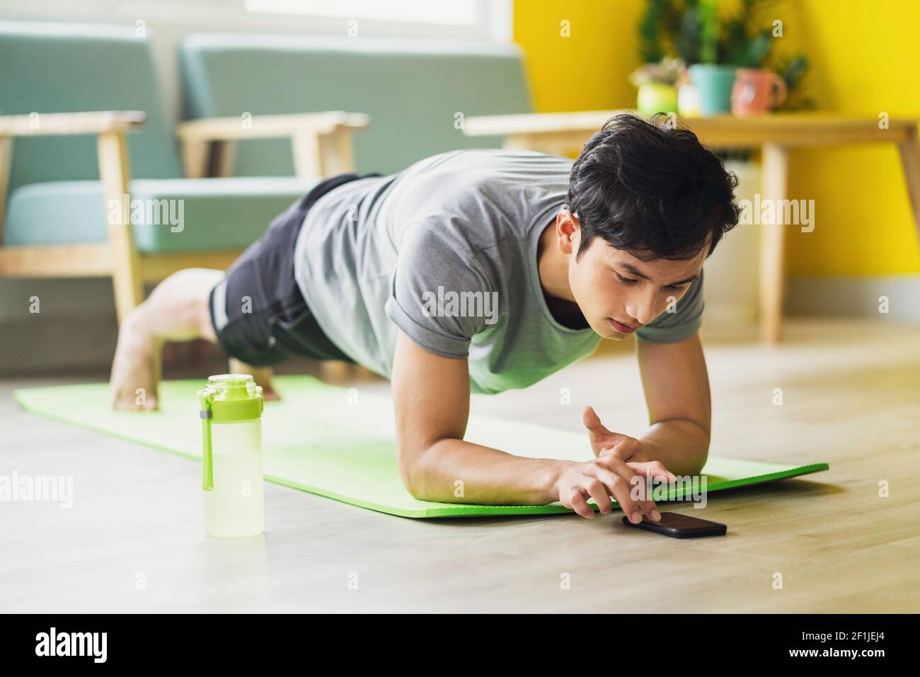 Asian man doing exercise at home Stock Photo