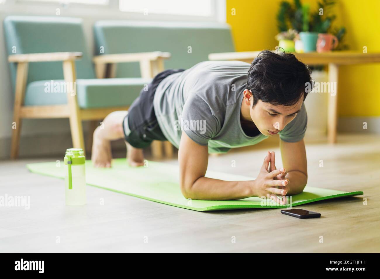 Asian man doing exercise at home Stock Photo