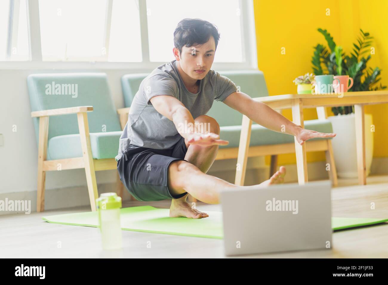 Asian man doing exercise at home Stock Photo