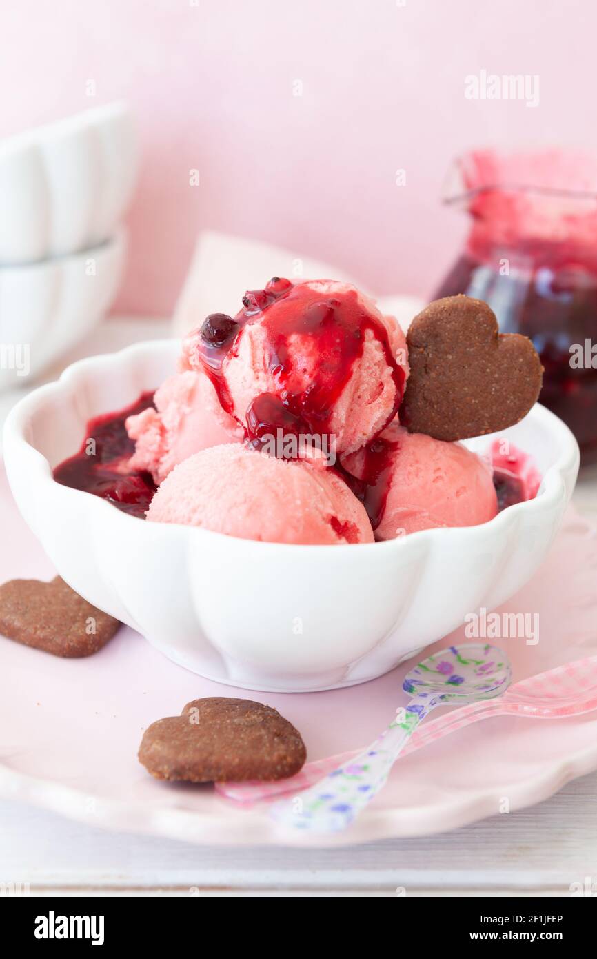 Raspberry ice cream with fruit sauce Stock Photo Alamy