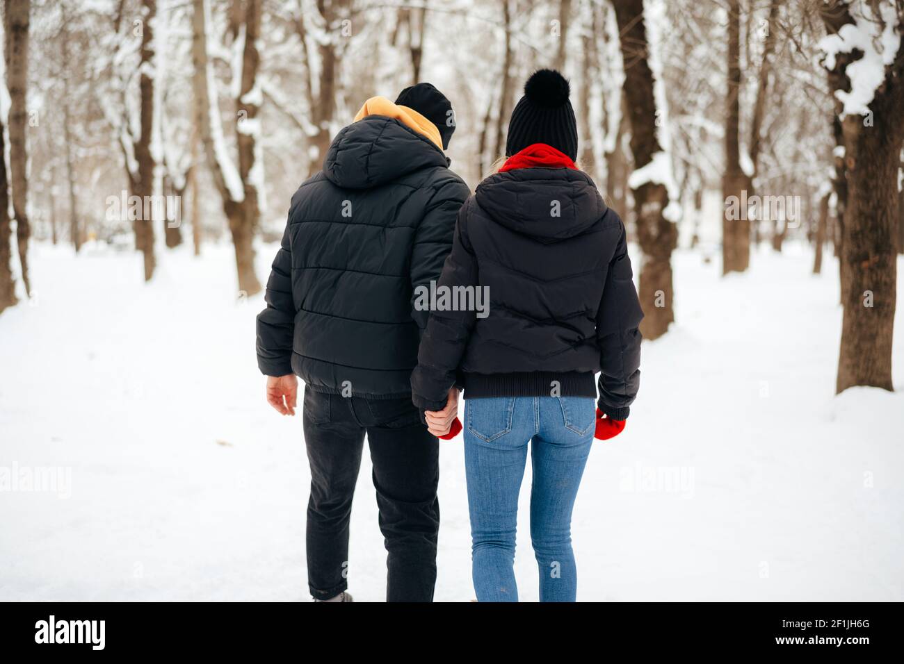 Young happy couple in love having a walk in a winter park Stock Photo ...