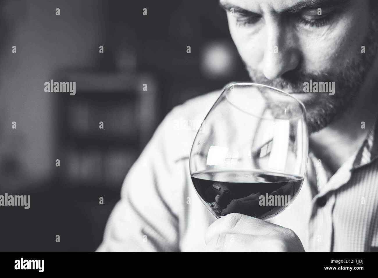 Man tasting a glass of red wine. Selective focus. Stock Photo