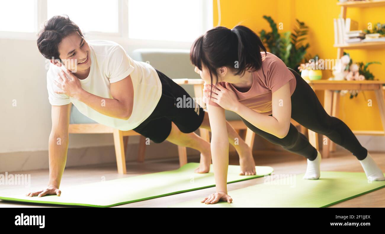 Asian couple doing exercise together at home Stock Photo