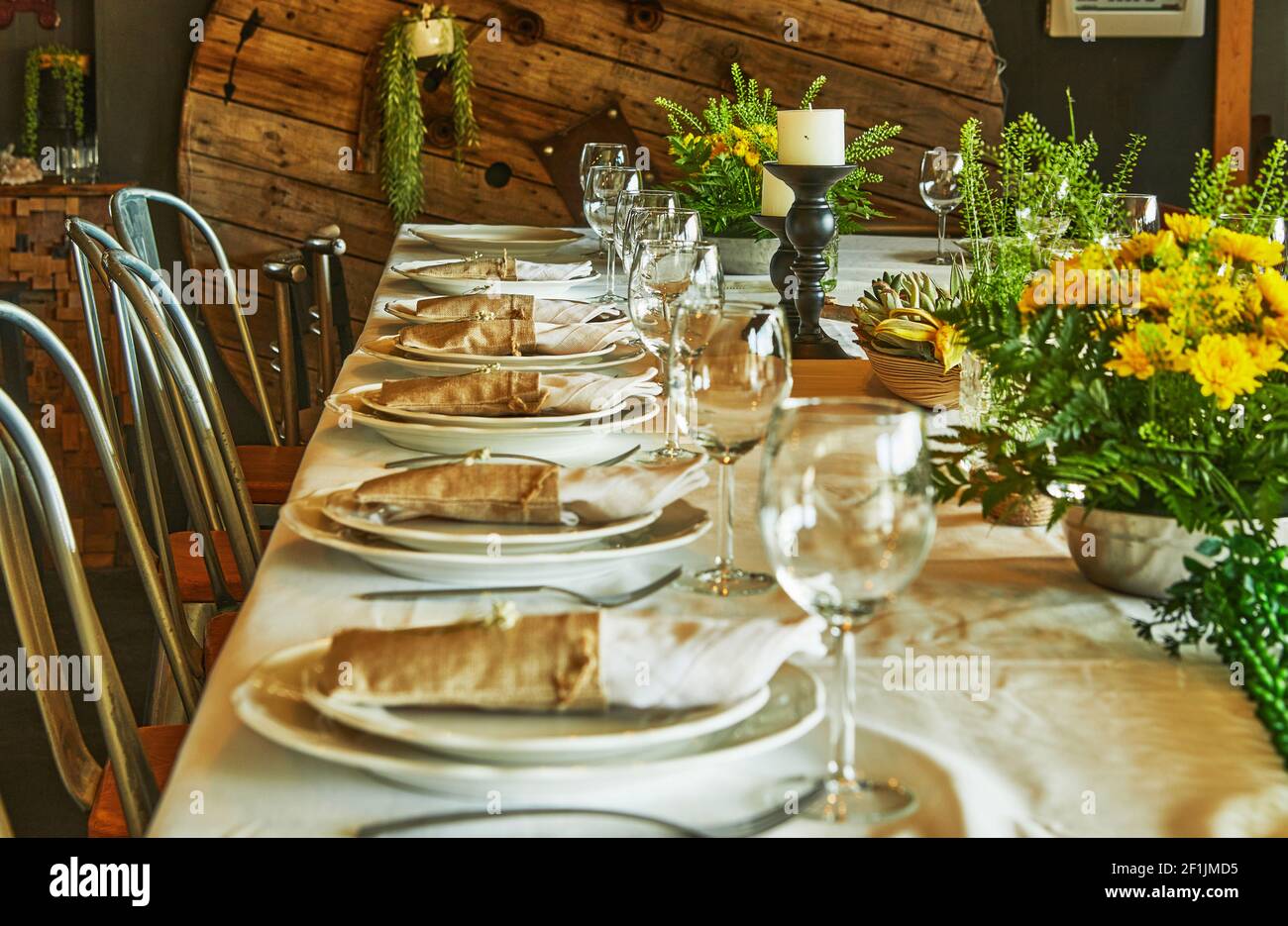Laid table with cutlery and crockery in the sunset sunlight Stock Photo